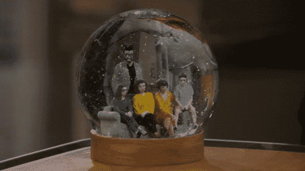 Schneider's snow globe featuring him and Lydia's family.