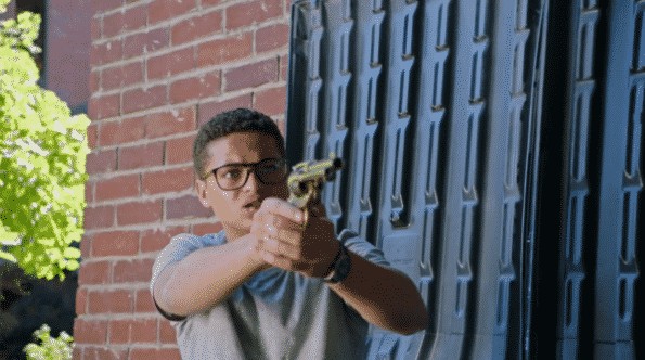 Wallace pointing a gun at Alex.