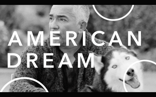 The words "American Dream" in front of Cesar as he is screenshot with a dog.