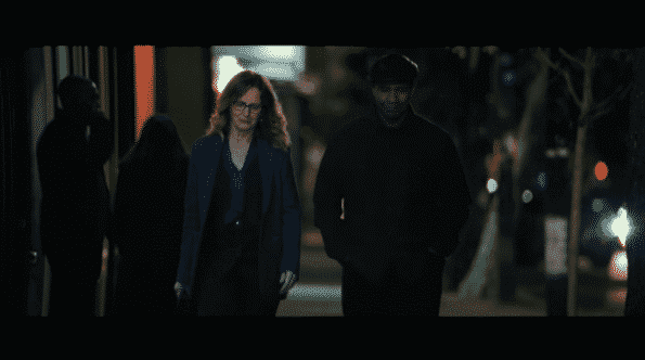 Susan and Robert walking down a street.