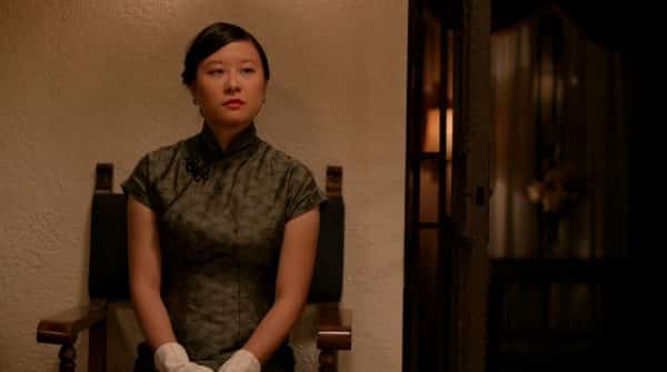 June watching her husband canoodle with white people as she awkwardly waits for him to finish.