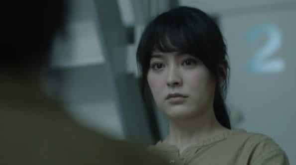 Shihori Kanjiya as Wato, talking to Sherlock after she interrogates a widow.