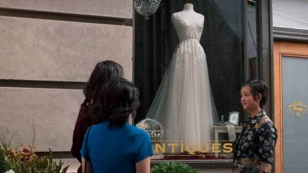 Andi pointing out a dress she'd think would be perfect for Bex.