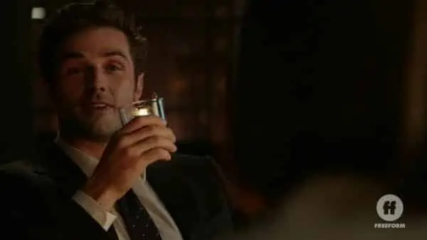 Jamie (Beau Mirchoff) having a drink.