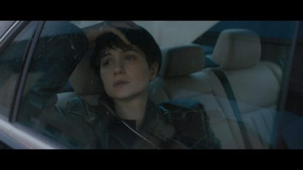 Katherine (Katherine Waterston) in transit somewhere.