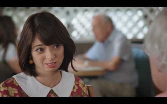 Jeannie (Kate Micucci) making a face while talking to her grandpa.