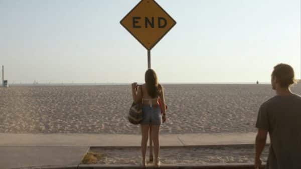 Amanda looking at a End sign.