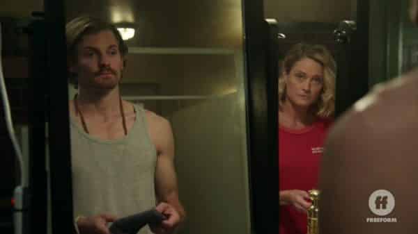 Dennis (Josh Pence) and Stef (Teri Polo) talking in the bathroom.