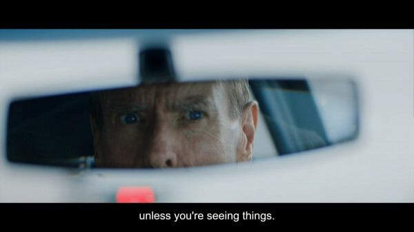 Braque (Timothy Spall) looking in his rear-view mirror.