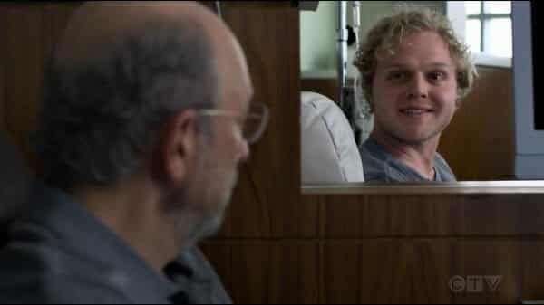 Larry (Joe Adler) smiling at Dr. Glassman.