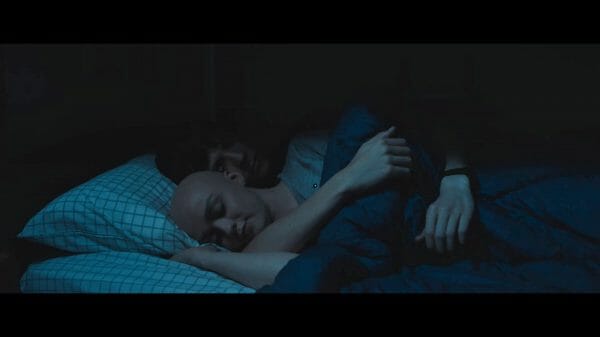 Skye (Maisie Williams) and Calvin (Asa Butterfield) cuddling.