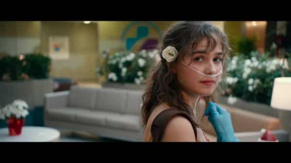 Stella (Haley Lu Richardson) with a flower in her hair.