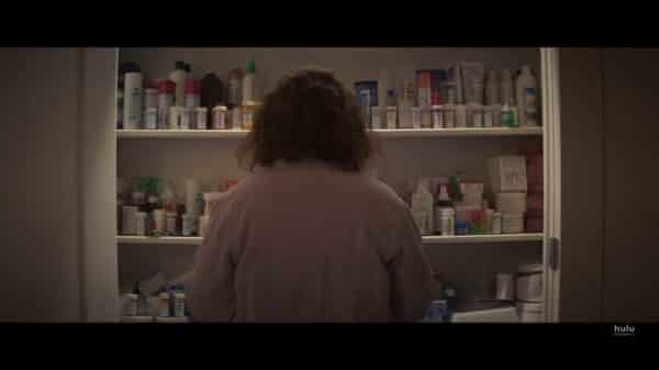 Dee Dee (Patricia Arquette) looking at a pantry filled with pills.