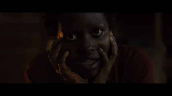 Red (Lupita Nyong'o) looking at the woman she is tethered to.