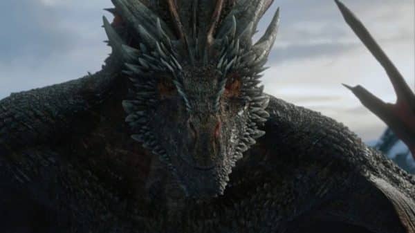 One of Daenerys' dragons looking on as she and Jon make out.