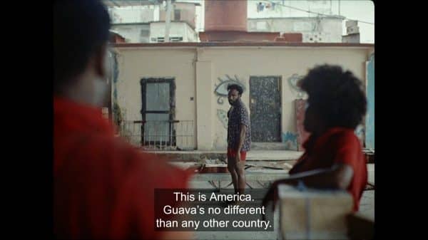 Deni (Donald Glover) noting that going to America wouldn't change things for his co-worker.