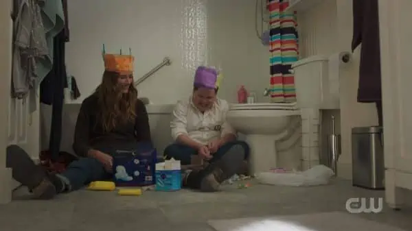 Murphy and Chloe in Dean's bathroom with pads and tampons on their heads.