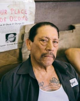 Miguel (Danny Trejo) taking a picture with a stern face.