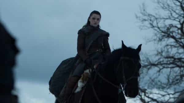 Sansa on a horse, following The Hound.