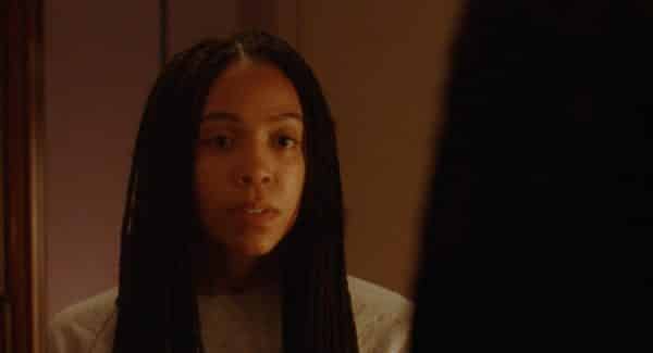 Ayanna (Zora Howard) looking into a mirror.