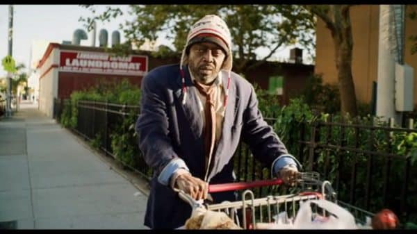 Crackhead Carl (Donnell Rawlings) walking with his cart.