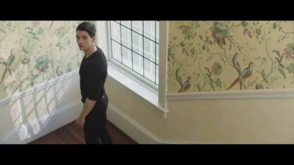 Henry (Steven Strait) walking down from upstairs.