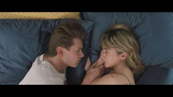 James (Drew Van Acker) and Sophie (Addison Timlin) in bed together.