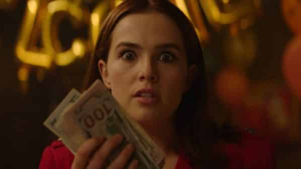 Peg (Zoey Deutch) holding hundreds of dollars.