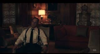 Commander Winslow (Christopher Meloni) sitting in his home.