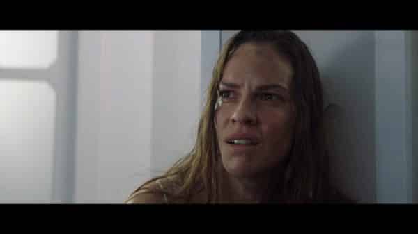 Woman (Hilary Swank) with a look of disbelief.