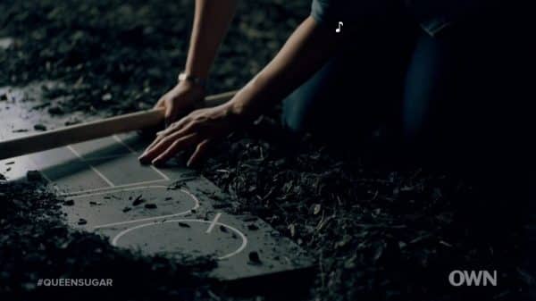 Charley cleaning the Queen Sugar sign.