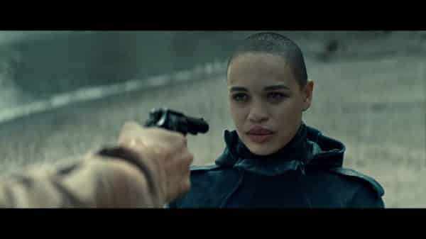 Rya (Cleopatra Coleman) with a gun pointed at her.