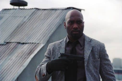 Detective Hart (James Black) taking out his gun.