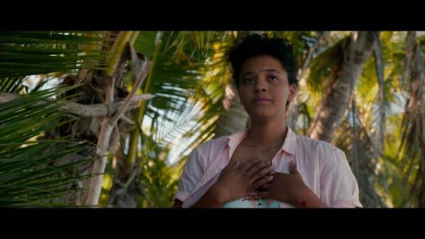 Jenn (Kiersey Clemons) with her hands on her chest.