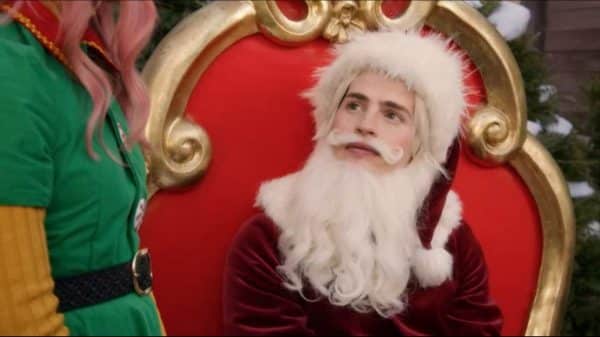 Nick (Gregg Sulkin) dressed as Santa.