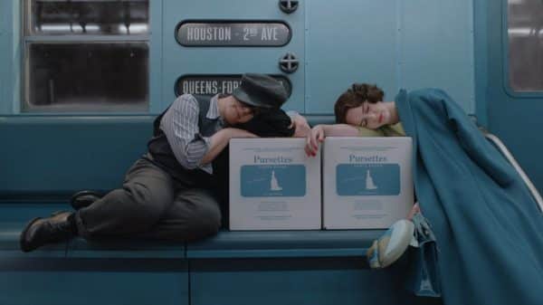 Susie and Miriam sleeping on boxes of tampons, on the subway.