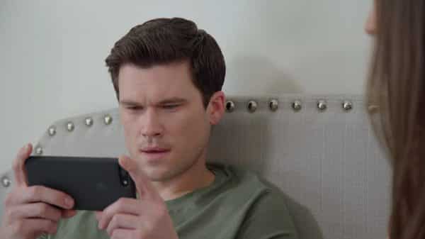 Owen (Josh Gilmer) on his phone.