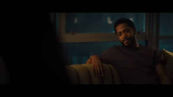 Mike (LaKeith Stanfield) sitting in Mae's home.
