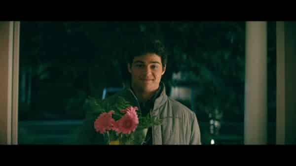 Peter (Noah Centineo) holding flowers for Lara Jean.