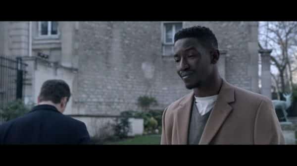 Elijah (Mamoudou Athie) learning his friend will no longer be able to support him financially.