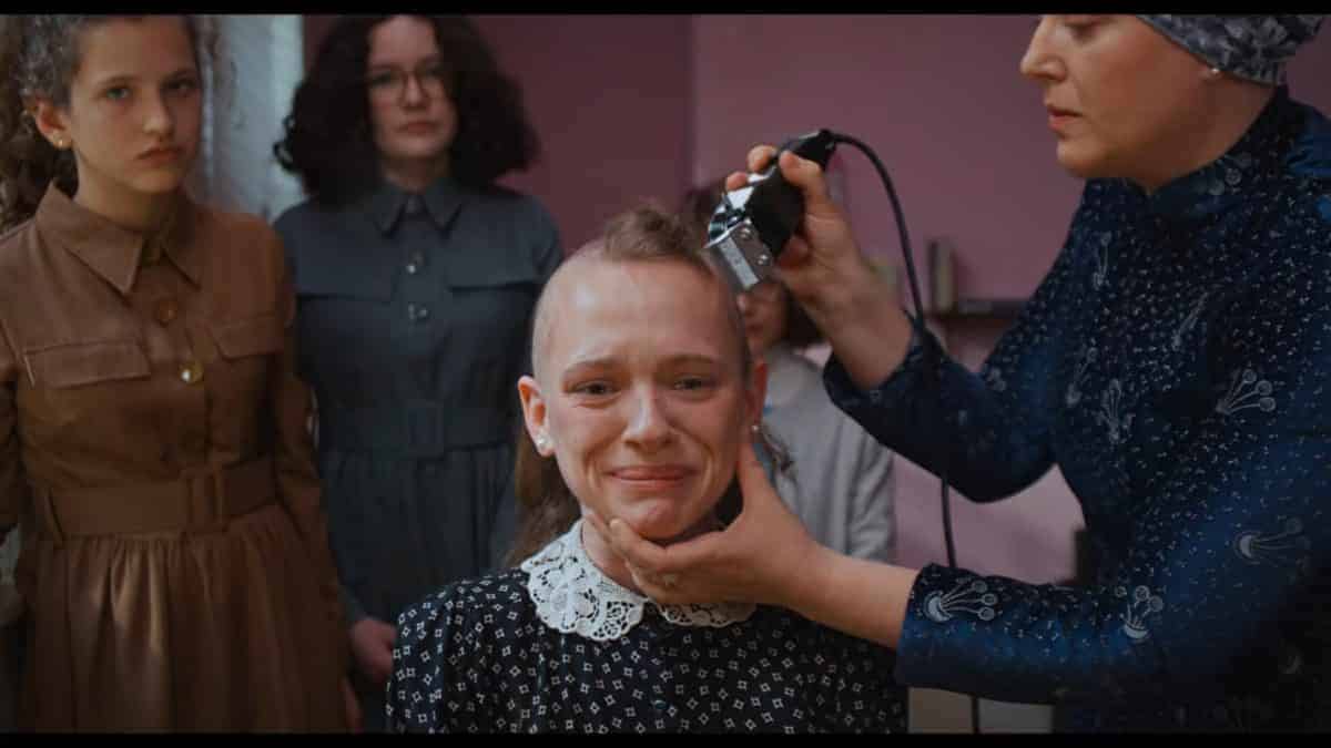 Esty having her hair cut off.