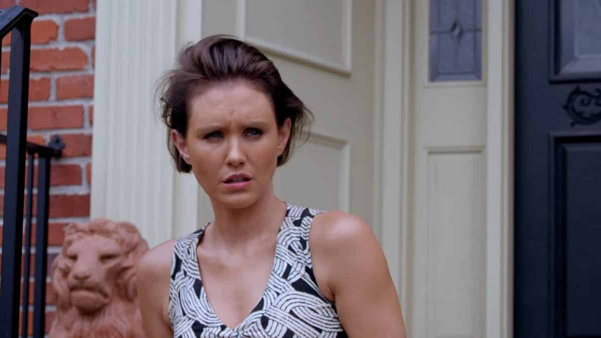 Lorna (Nicky Whelan) coming out of her house.