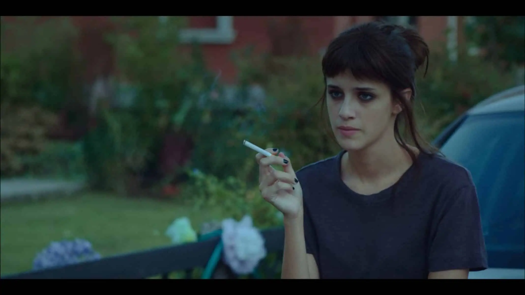 Anna (Bendetta Porcaroli) with a cigarette on hand.