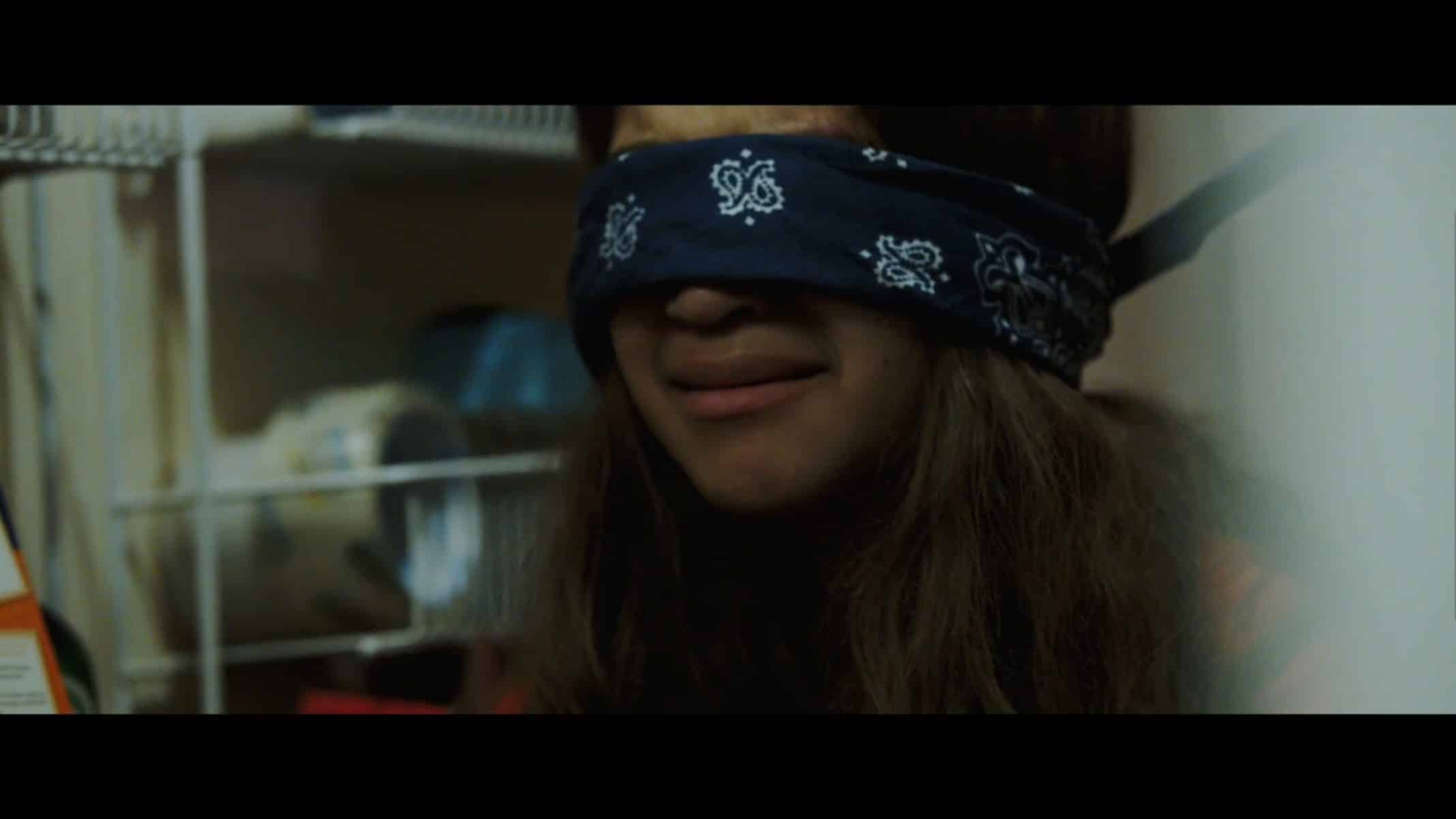 Keisha (Ava Justin) with a bandana over her eyes.