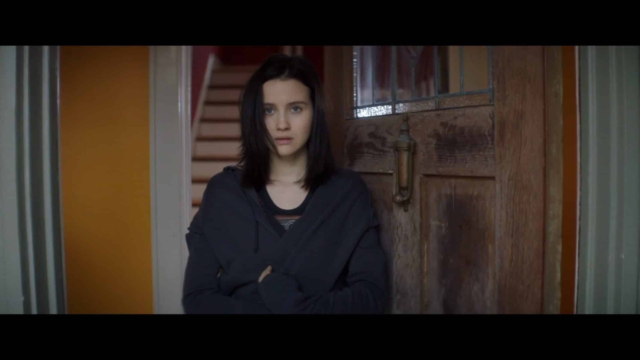 Alex (Julia Goldani Telles) at her doorway in "Looks That Kill."