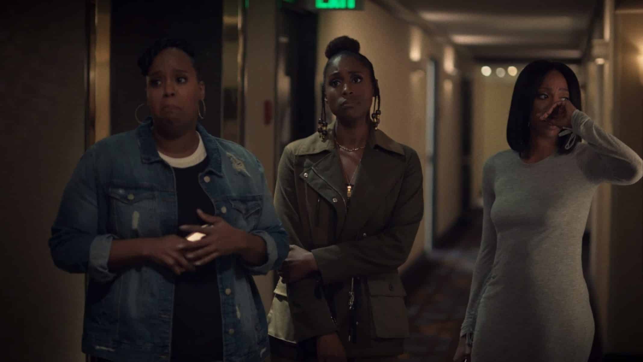 Kelli, Issa, and Molly standing outside a hotel room door, hoping for the best when Tiffany opens the door.