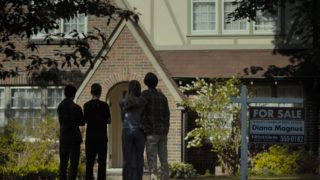 The lead cast, and Matt's friend, in front of their now on sale home.