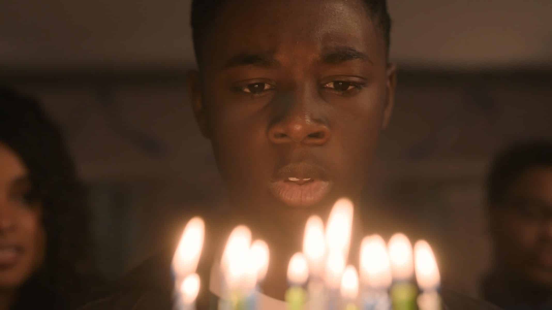 Kevin (Alex R. Hibbert) blowing out his birthday candles