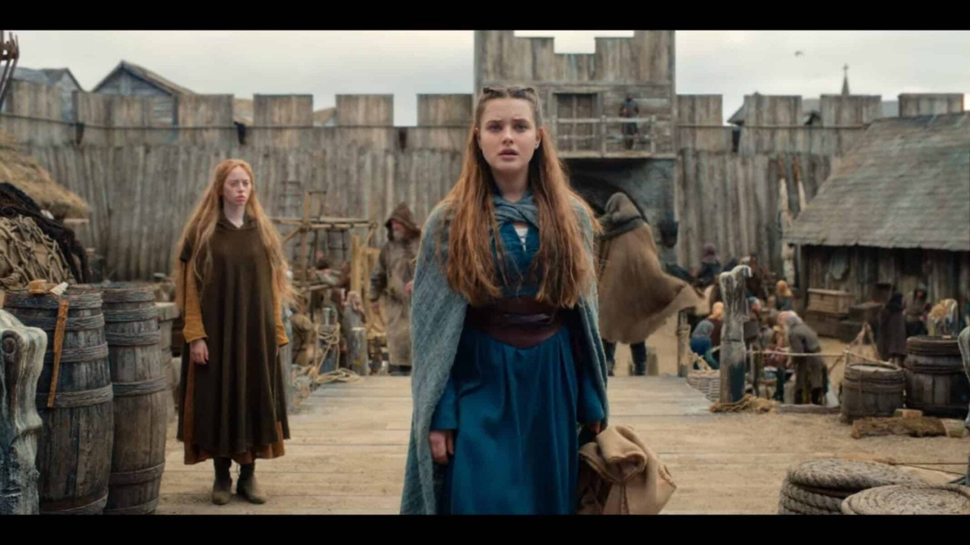 Nimue (Katherine Langford) entering a port town.