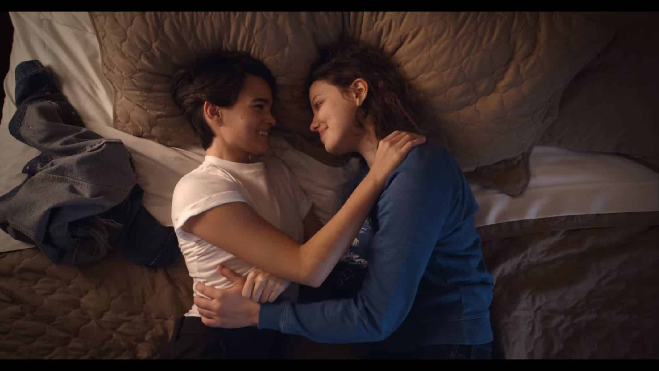 Elodie and Jillian in bed cuddling.